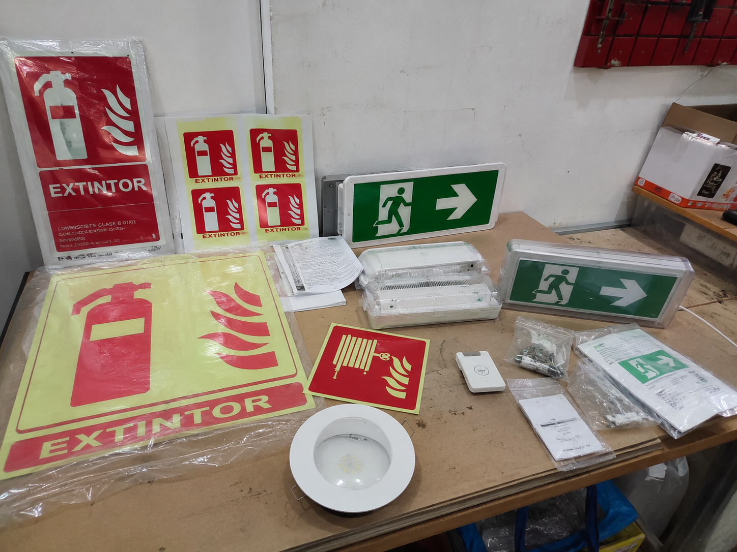 Señal fotoluminiscente de salida y luminaria de emergencia en un pasillo de evacuación en Castellón